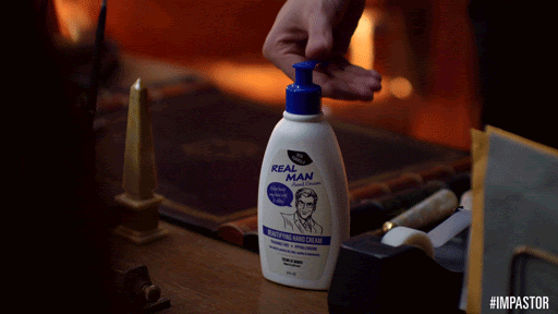A man pumping out lotion which has a bottle that says ‘Real Man’
