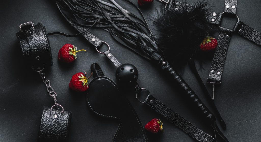 A bondage kit with strawberries placed around it.