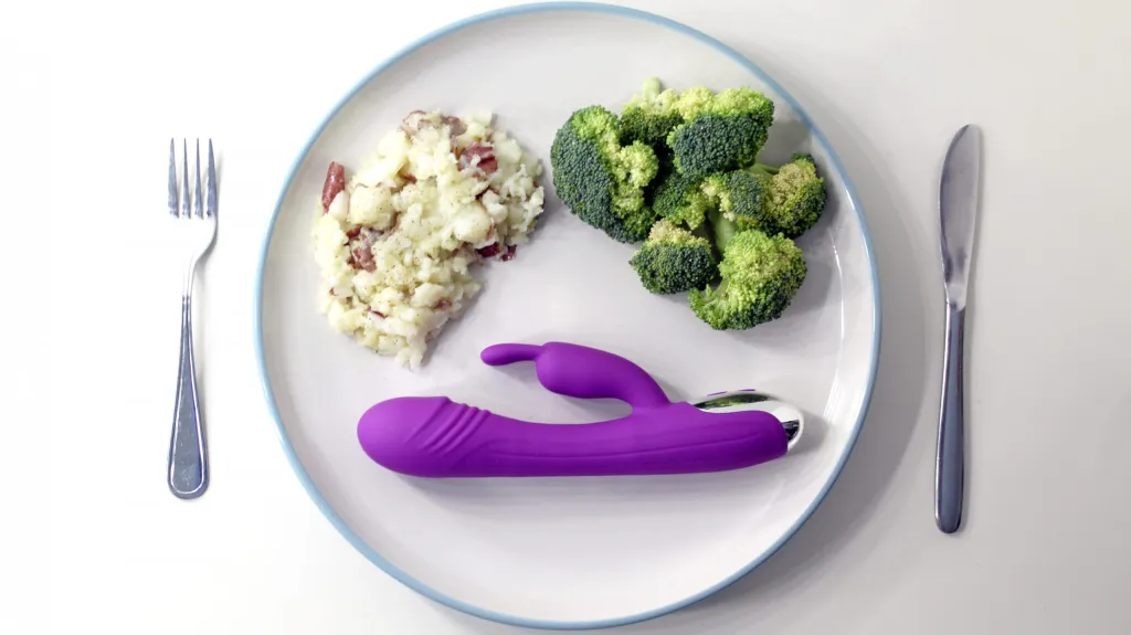 A Dildo served on a plate on the side of broccoli and mash